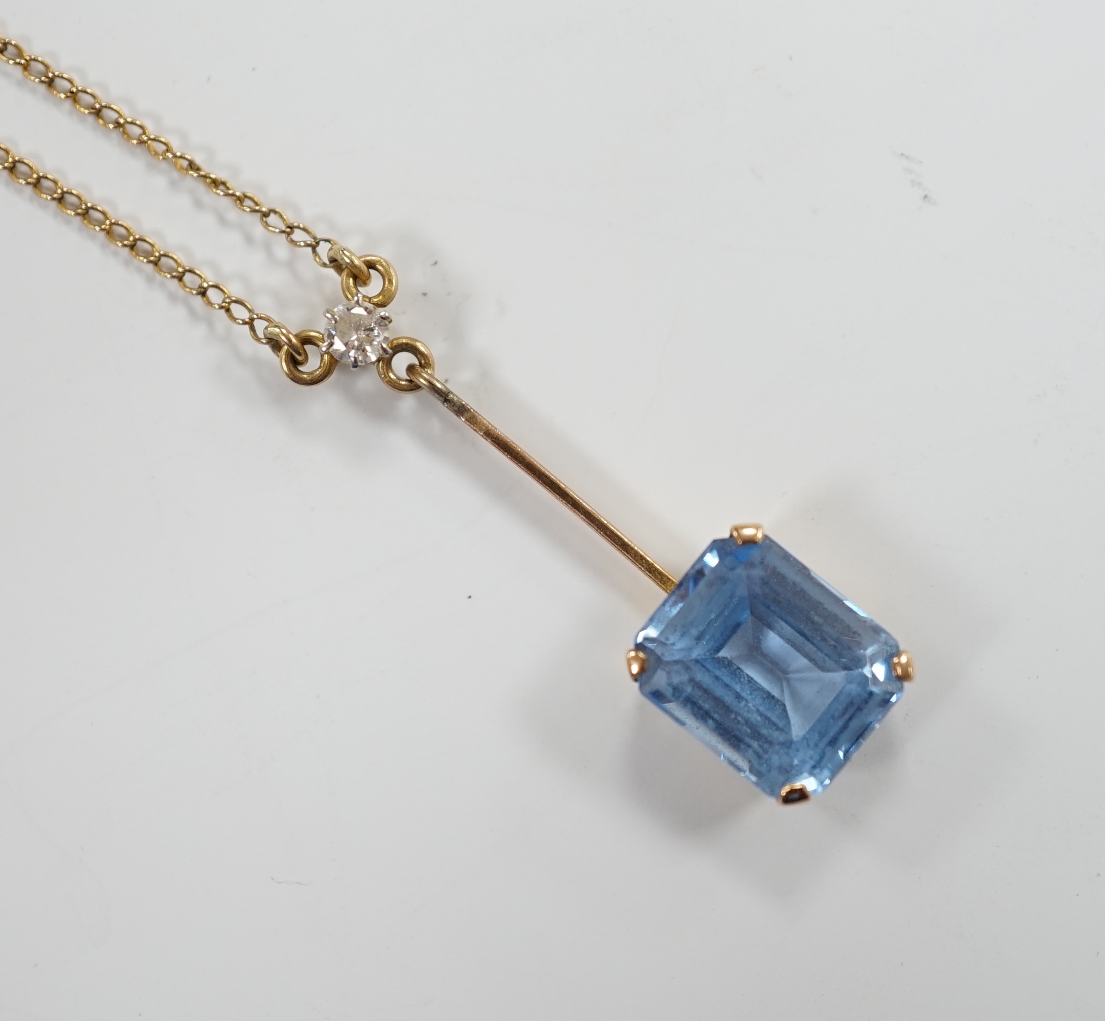 A 9c, single stone synthetic blue spinel and single stone diamond set drop pendant necklace, 44cm, gross weight 4 grams.